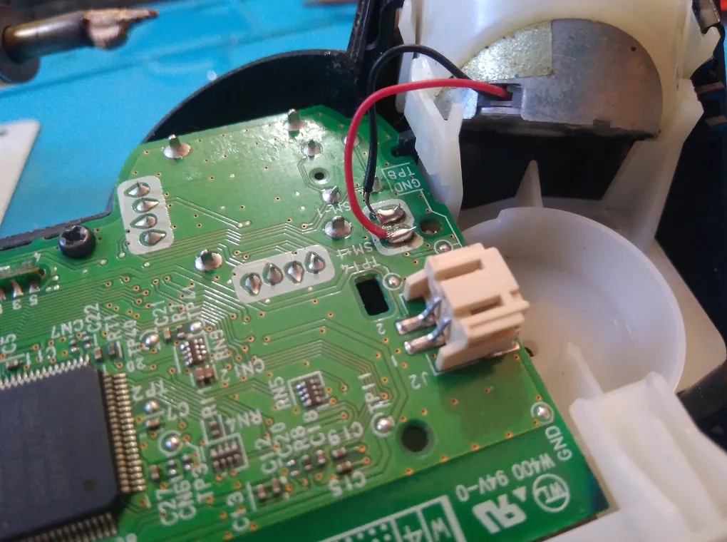 Internal view of DualShock 3 controller with emphasis on the printed circuit board (PCB).